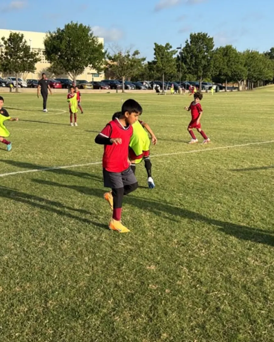 A young player practicing close ball control